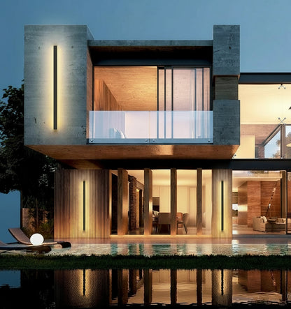 Modern house exterior with outdoor wall lamps at dusk