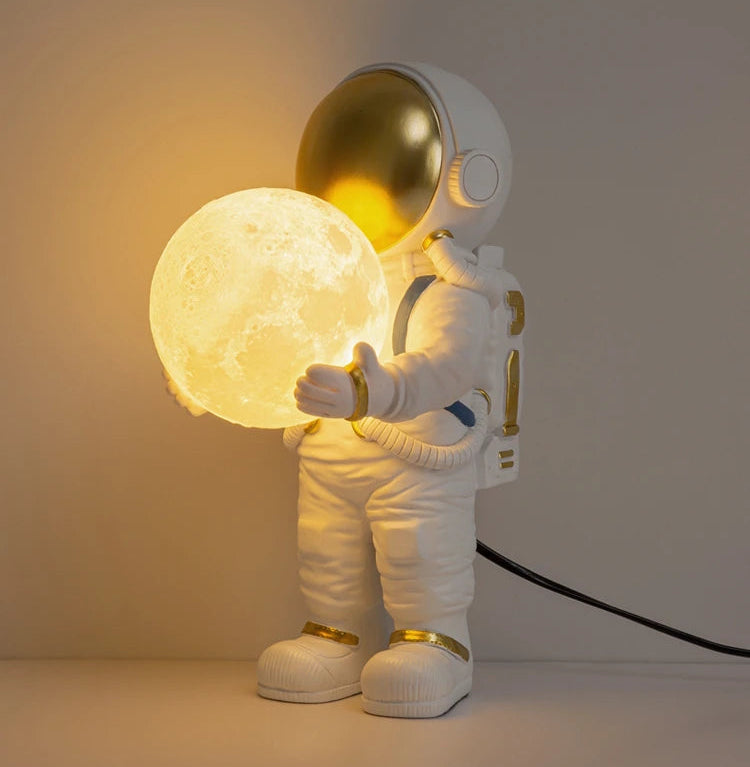 Decorative lamp shaped like an astronaut holding a moon, 