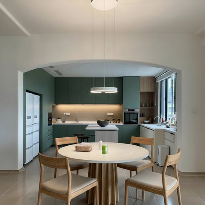 Modern kitchen with dining area featuring a round table and chairs.