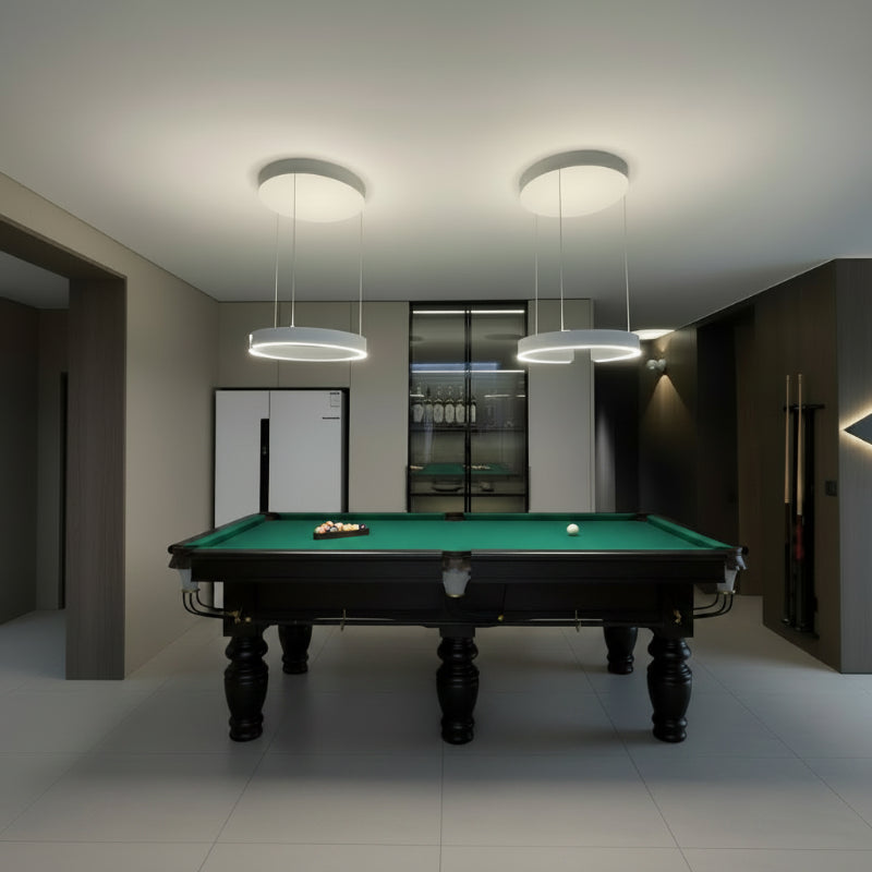Modern game room with pendant lights and refrigerator.