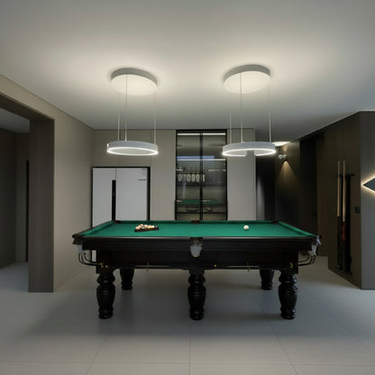 Modern game room with pendant lights and refrigerator.