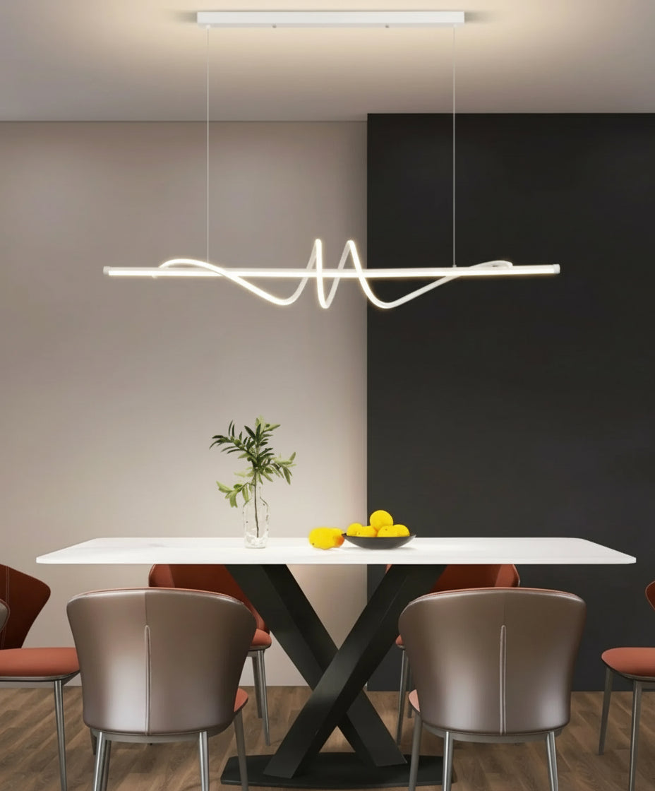 Modern dining room with a white table, chairs, and a unique pendant light fixture.