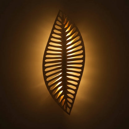 Decorative wall light fixture with leaf pattern on a neutral background