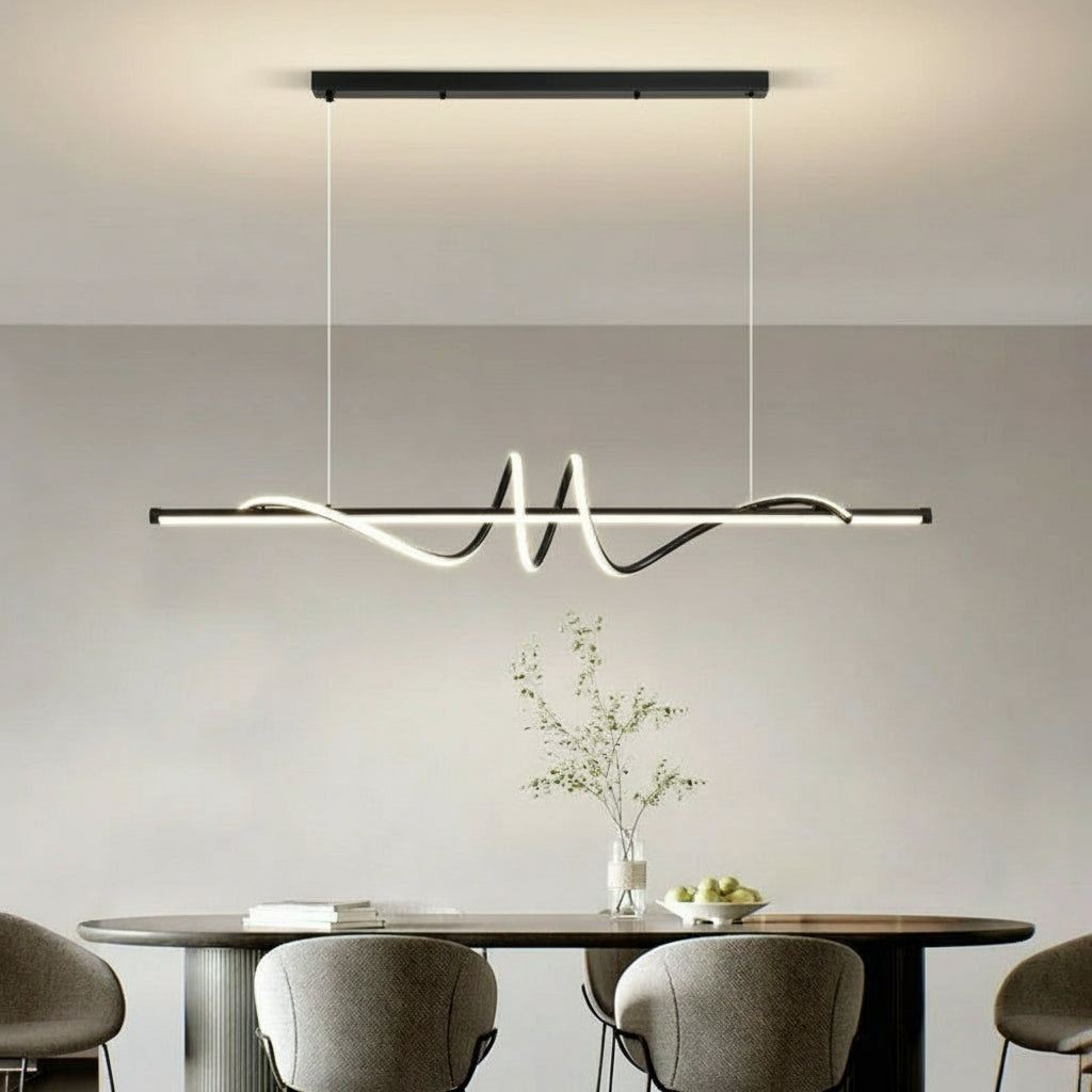 Modern pendant light hanging above a dining table with chairs in a minimalistic room.