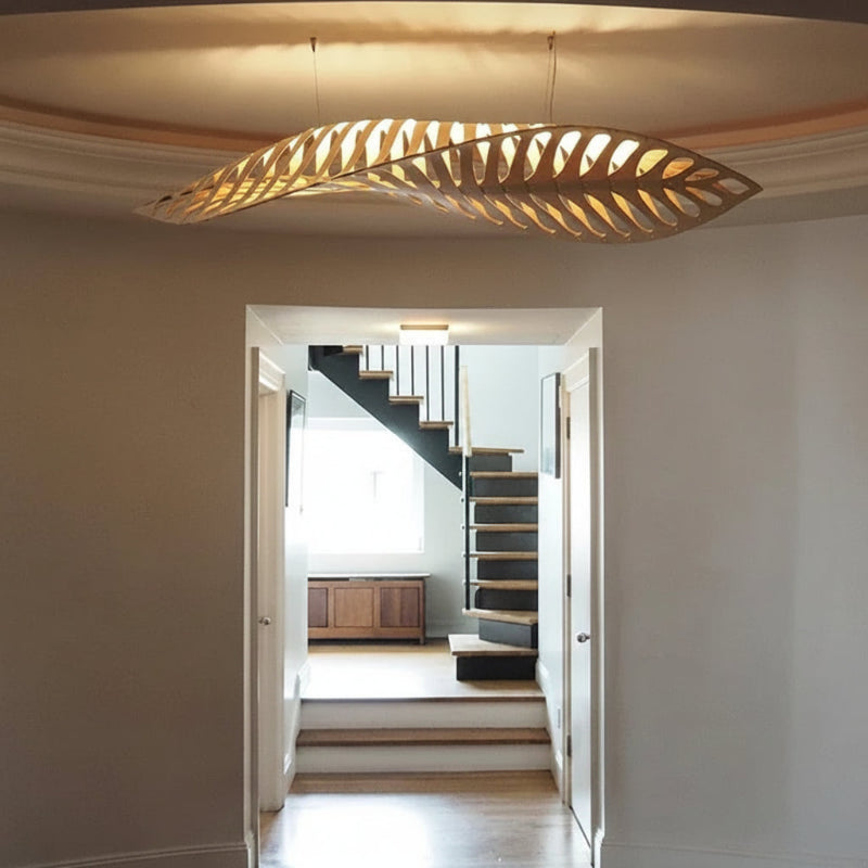 Modern chandelier hanging above a staircase in a home interior.